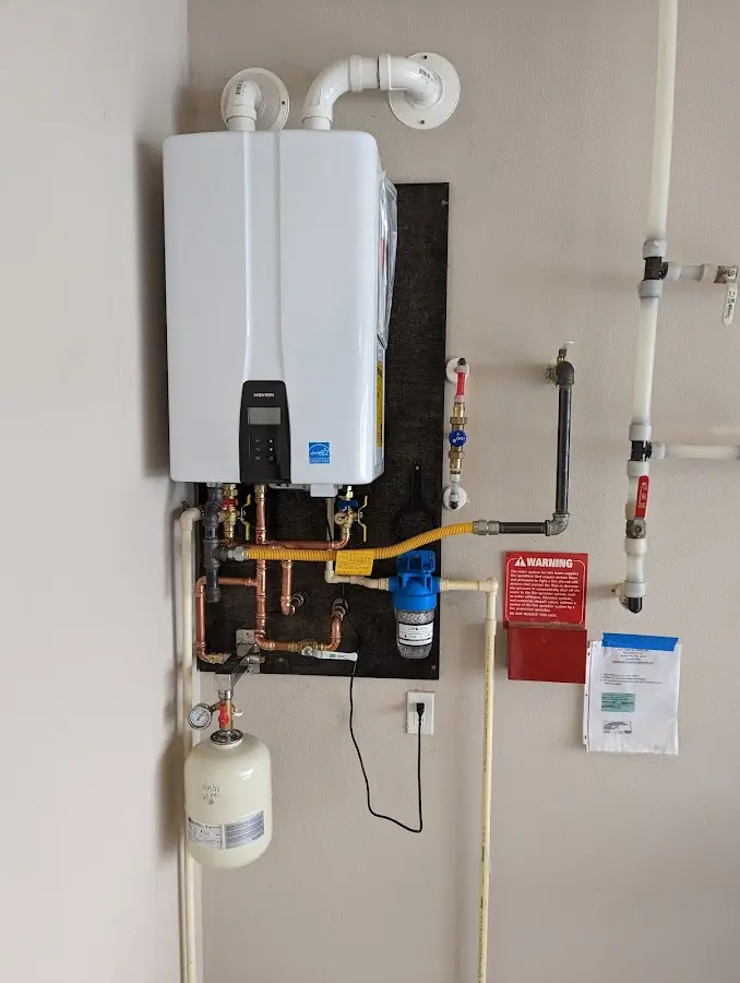 Professional plumber installing copper piping in a Round Lake Park home